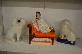 Staffordshire figure of reclining musician on a chaise longue together with two Staffordshire