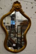 A decorative gilt framed mirror.