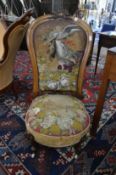 A Victorian walnut framed and upholstered chair with bead work decoration.