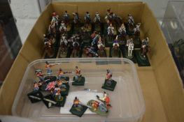 A group of small painted die-cast military figures on horseback and others similar.
