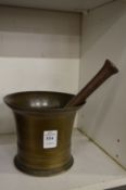 A brass pestle and mortar.