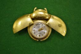 An unusual ladybird watch, the wings opening to reveal the watch face.