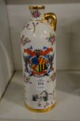An armorial decorated porcelain liqueur bottle.