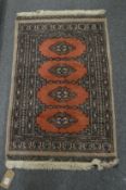 A small modern Bokhara style rug, 95cm x 60cm.