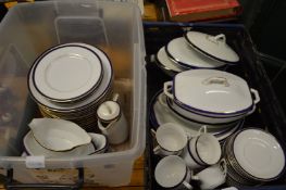 A quantity of blue and gilt decorated dinnerware.