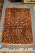 A small Persian rug, rust ground with stylised decoration, 130cm x 88cm.