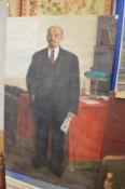 Russian School, Full length portrait of Lenin holding a newspaper standing by a table, oil on