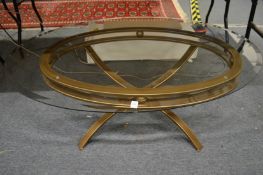 A stylish glass top oval shaped coffee table.