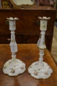A pair of early 19th century enamel candlesticks with floral decoration.