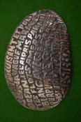 A Christofle plated pebble shaped paperweight inscribed with a poem.