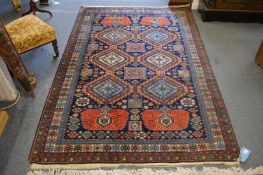 A good Persian design carpet, blue ground with panels of geometric stylised flower head