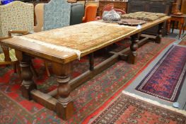 A good large oak refectory dining table, the rectangular top supported on six columns united by