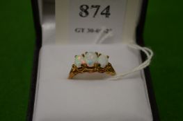 A 9ct gold and opal three stone ring, size M½.
