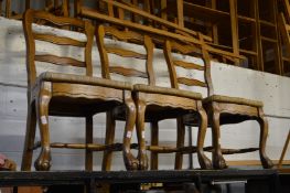 A set of three rush seated dining chairs.