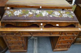 A Victorian walnut fender foot stool with bead work decorated drop-in panel.