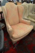 A George II design wing armchair.