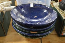 A group of glazed terracotta bowls.