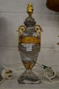 A marble and ormolu urn shaped table lamp.