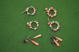 Silver and coral earrings and studs.