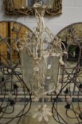 A cream painted wrought iron hall lantern.