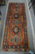 A good Persian small runner or hall carpet, red ground with five large geometric panels, 205cm x
