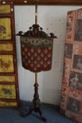 A Victorian bead work banner pole screen on tripod base.
