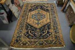 A Persian rug, blue and cream ground with stylised decoration, 195cm x 130cm.