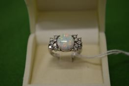A decorative silver and opal ring, size M½.