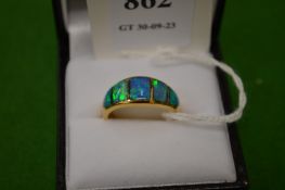An 18ct gold and opal five stone ring, size M.