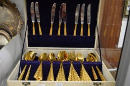 A gilt metal canteen of cutlery.