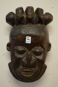 A carved wood tribal mask.