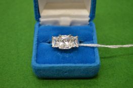 A decorative silver ring, size N.