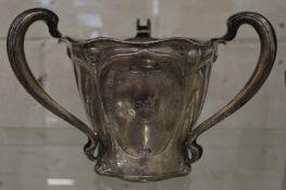 A good art nouveau silver tyg or loving cup with engraved crest.