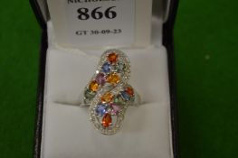 An 18ct gold and multi-coloured gem set crossover ring, size ).
