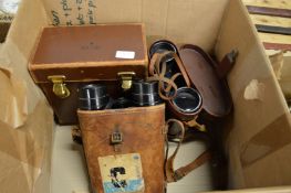 Two pairs of binoculars and a leather box.