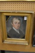 19th century bust length portrait of gentleman in a verre eglomise and giltwood frame.