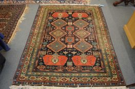 A good Persian design carpet, blue ground with stylised panels, within a similar border, 190cm x