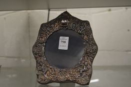 An embossed silver photograph frame.