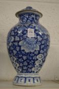 A Chinese blue and white baluster shaped vase and cover.