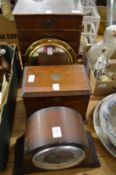 A mantle clock, table top cabinets, small mirror and a table top chest of drawers.