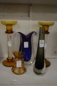 Stylish glassware to include three vases and a pair of candlesticks.