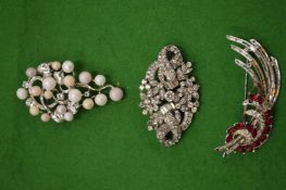 Three decorative brooches.