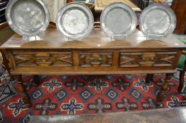 An 18th century oak dresser with three geometrically moulded drawers on turned legs.