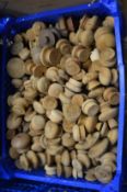 A large quantity of turned wooden door knobs.