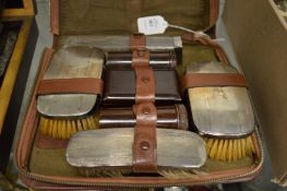 A Gentleman's travelling case with silver backed brushes etc.