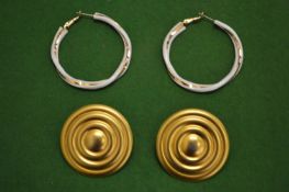 Two pairs of designer earrings.