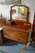 An Edwardian inlaid mahogany dressing chest.