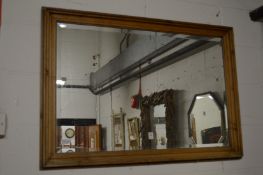 A rectangular pine frame mirror.