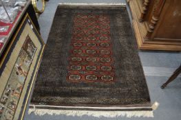 A good modern Bokhara rug, signed, 190cm x 120cm.