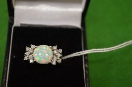 A decorative silver and opal ring, size M½.